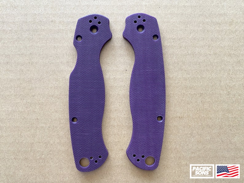 May include: Two purple knife scales with a textured surface and multiple holes for mounting.