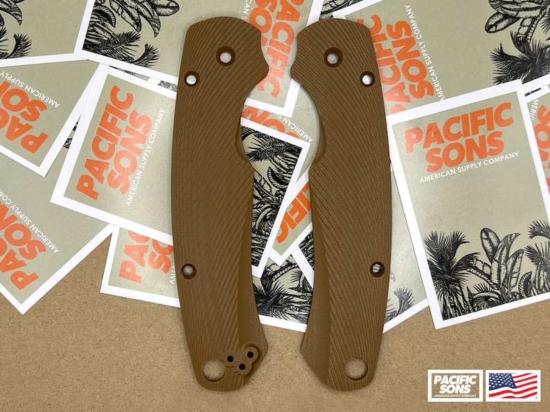 May include: Two brown textured knife scales with rounded edges and multiple holes. The scales are on a brown surface with several white stickers that say "Pacific Sons American Supply Company".