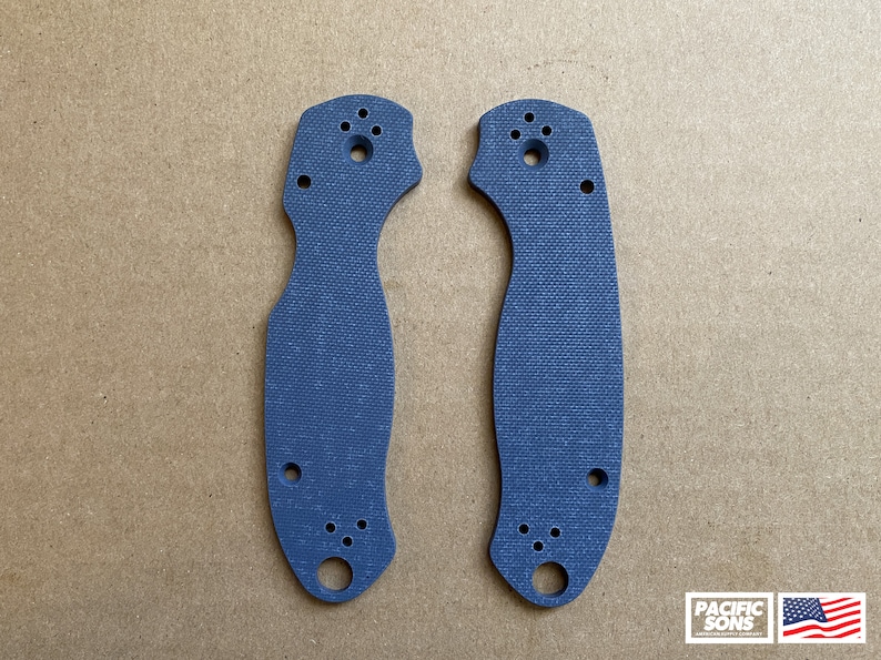 May include: A pair of blue G10 knife scales with a textured surface and multiple holes.