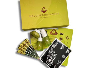 May include: A yellow box set from Hollywood Henna, Los Angeles, containing various beauty products. The set includes henna cones, skincare bottles, and a black and white floral stencil. The box and packaging are a bright yellow color.