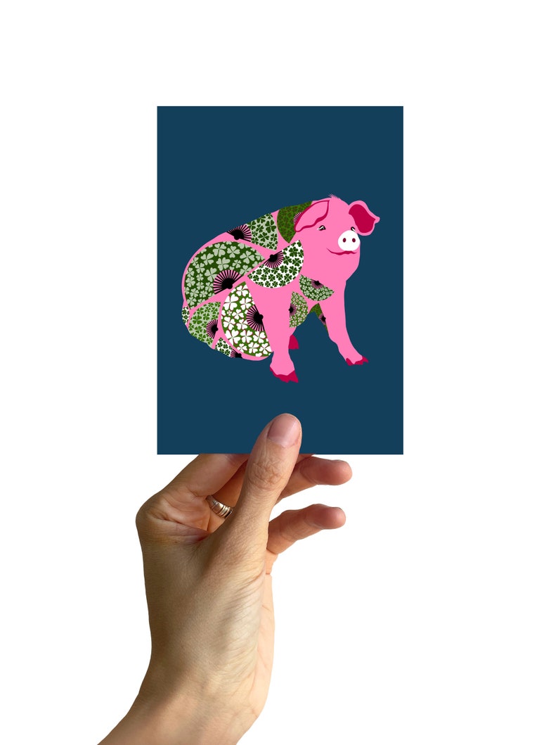 May include: A pink pig with a floral pattern on its body, against a dark blue background.