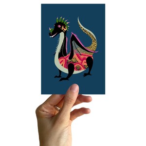 May include: A black and green dragon illustration with a pink and yellow patterned body on a dark blue background.