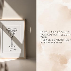 May include: A black and white line drawing of a martini glass on a white background. The image is framed in a light wood frame.