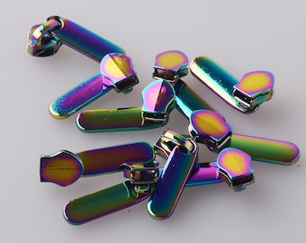 May include: A group of iridescent zipper pulls in various rainbow colors. The pulls are made of metal and have a smooth, shiny finish.