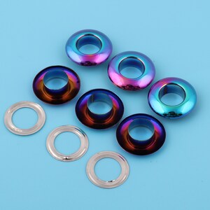 May include: Assortment of metal eyelets in various sizes. The eyelets are silver and iridescent with a rainbow finish.
