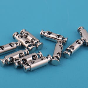 25*8mm Metal Double Hole Cord Lock Biswitch Cord Lock Spring Rope Plug Switch Stopper Fastner Slider Shoelace Purse Accessories