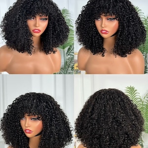 May include: A black curly bob wig with bangs. The wig is styled in a short, voluminous bob with tight curls and a full fringe. The wig is displayed on a mannequin head.