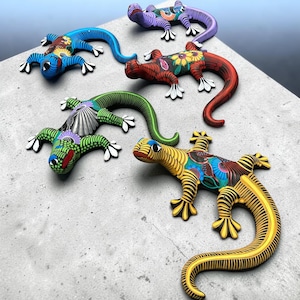 May include: Five lizard figurines arranged in a group, each featuring distinct hand-painted patterns. The colors include blue, purple, red, green, and yellow, with intricate black and white details on their bodies, tails, and feet.