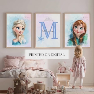 May include: Three framed watercolor prints featuring characters from a popular animated film. The prints include portraits of two characters and a personalized initial with a crown and snowflake. The text "PRINTED OR DIGITAL" is displayed below the prints.