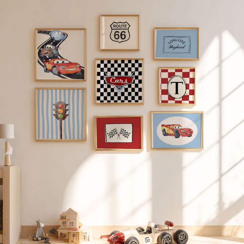 May include: A collection of framed wall art featuring a racing theme. The artwork includes images of race cars, a Route 66 sign, checkered flags, and a traffic light. The frames have gold-colored borders, and the color palette includes red, blue, and black.