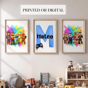 May include: Three framed prints with a light wood finish. The prints feature colorful watercolor backgrounds and cartoon characters. One print has the name "Mateo" with a blue "M" and a game controller. The text "PRINTED OR DIGITAL" is at the top.