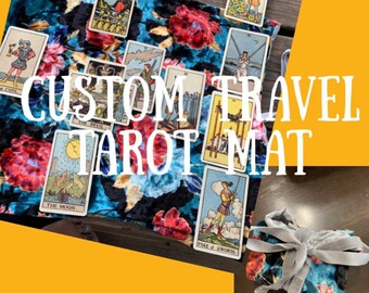 May include: A custom travel tarot mat made from blue velvet fabric with floral patterns. The mat is rolled up and tied with a grey ribbon. The mat is laid out flat with tarot cards on top of it. The text "CUSTOM TRAVEL TAROT MAT" is superimposed on the image.