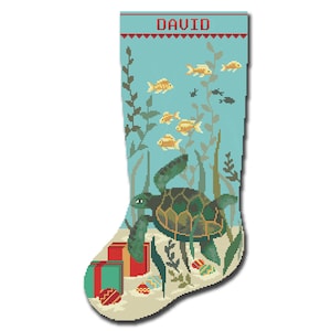 May include: A blue and green Christmas stocking with the name "DAVID" embroidered on the top. The stocking features a sea turtle swimming among yellow fish and green seaweed. There are red and green wrapped presents at the bottom of the stocking.