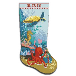 May include: A Christmas stocking with a seahorse, octopus, and turtle design. The stocking is blue and green with a yellow turtle and a red octopus. The stocking has the name "OLIVIA" at the top.