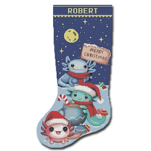May include: A blue Christmas stocking with the name "ROBERT" at the top. The stocking features a night sky with stars and a moon, and three axolotls wearing Santa hats. The axolotls are holding a mug of hot chocolate and a candy cane. The stocking also has a sign that says "Merry Christmas".