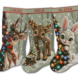 May include: Three Christmas stockings featuring a light green background with white snowflakes. The stockings are personalized with the names LUCAS, MILO, and OLIVIA. Each stocking displays a different animal: a reindeer, a fawn, and a rabbit.