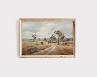 May include: A framed painting of a dirt road winding through a field with trees and a cloudy sky in the background.