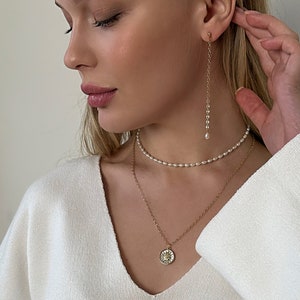 pearl chocker and chain necklace with sun pendant