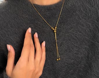 Verstelbare gouden lariatketting, set niet-aantasting bolo tie en oorringen