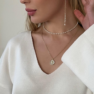 pearl chocker and chain necklace with sun pendant