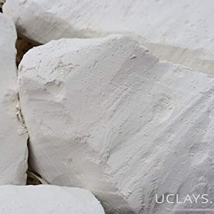 May include: White chalk rocks, a natural material used for drawing and writing. The rocks are rough and textured, with a white colour.