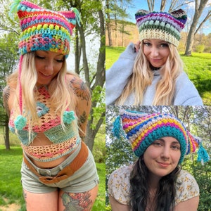 May include: Three women wearing colorful crocheted hats. The hats are all different styles and colors, but they all have a whimsical and bohemian feel. The women are all smiling and looking happy.