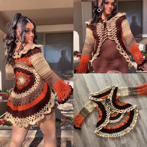 May include: A crocheted cardigan with a brown, beige, and orange color scheme. The cardigan has a bell sleeve and a scalloped hem.