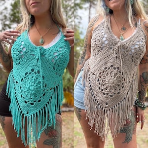 May include: Two crochet halter tops. One is turquoise, the other is tan. Both have a floral design, fringe, and a tie at the neckline. The tops are handmade and suitable for summer wear. The crochet tops are a bohemian style.