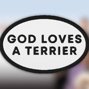 May include: White oval patch with a black border and the text "GOD LOVES A TERRIER" in black.
