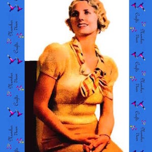 May include: A vintage-style yellow short-sleeved knit top with a fitted waist and a textured surface. The garment features a decorative neck scarf with horizontal stripes in shades of red, orange, and yellow, secured with a small circular button.