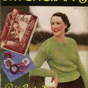 May include: A vintage magazine cover for Stitchcraft magazine, issue number 6, from October 1936. The cover features a woman wearing a green knitted sweater and a brown skirt. The magazine cover also features a book titled "Stitchcraft's Book of Gifts" and a blue and white embroidery design.