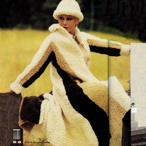 May include: A woman wearing a cream-colored, long coat and matching hat. The coat features vertical stripes of brown and black. The coat is made of a textured, fuzzy material. The text at the bottom of the image reads "Actress Joanna Lumley."