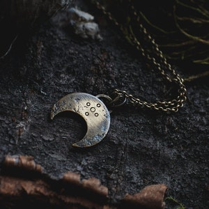 tiny brass lunula with delicate chain · magical · rustic ·