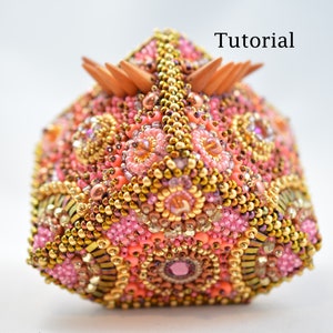 May include: A pink, gold, and brown beaded box with a geometric design. The box has a wooden top with a pointed design. The text "Tutorial" is visible in the upper right corner of the image.