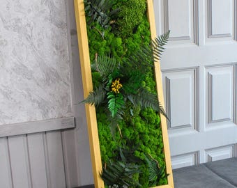 May include: A framed moss wall art piece with a variety of green moss and ferns. The frame is a light gold color.