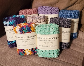 May include: A collection of colorful crocheted washcloths with labels that read "Unchained Treasures handmade with love 100% Cotton Washcloth".