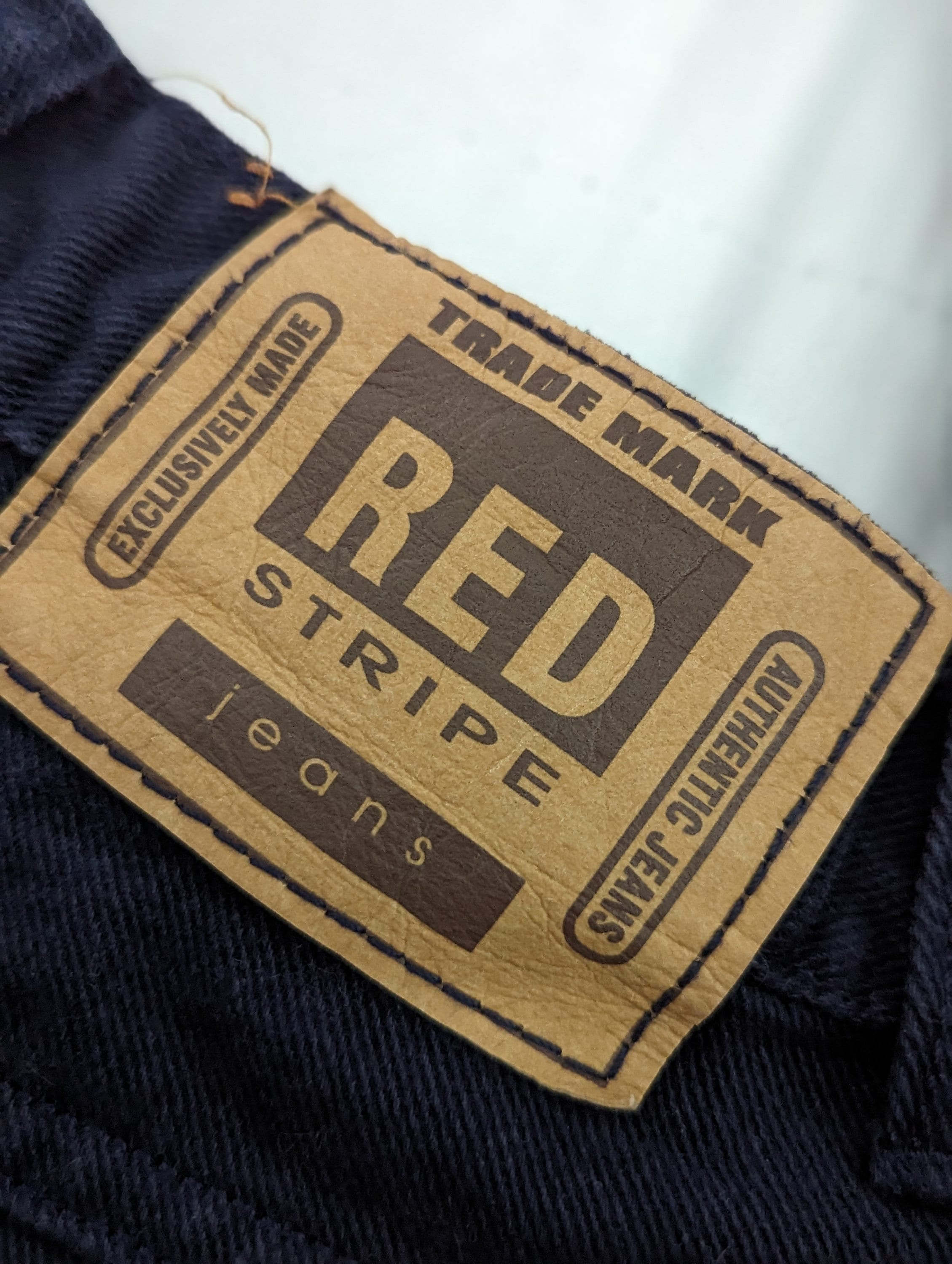Blue jeans with red stripe hot sale