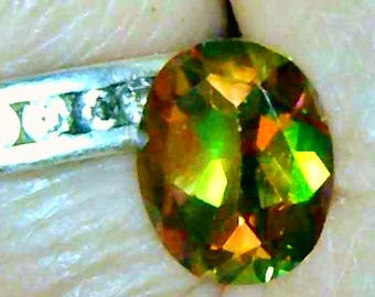 Mango Topaz, treated, Loose Gemstone, 10  x 8 mm Oval, approx 2.8 carats, Orange with red,green and blue flashes