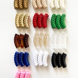 May include: A set of 15 twisted plastic hair clips in various colors, including gold, beige, white, red, green, brown, clear, blue, black, and pink.