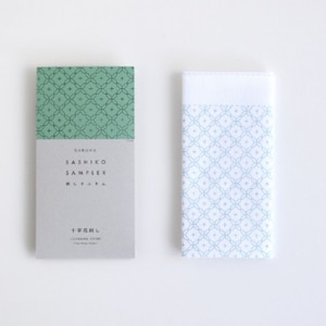May include: A green and white Sashiko sampler with the text "Sashiko Sampler Natural" and "十文字" printed on the front. The sampler is a guide for learning the traditional Japanese embroidery technique of Sashiko.