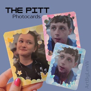 May include: Three rectangular photocards featuring scenes from The Pitt. One card has a yellow border with stars and butterflies, while the other two have pink and blue glittery borders with circular and butterfly accents. Text reads THE PITT.