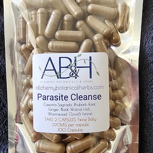 May include: A bag of 100 brown capsules labeled "Parasite Cleanse" with the ingredients Cascara Sagrada, Rhubarb Root, Ginger, Black Walnut Hull, Wormwood, Clover & Fennel. The label also states to take 2 capsules twice daily and that each capsule contains 390mg.