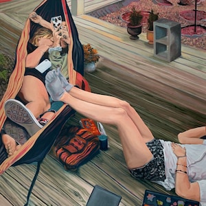 May include: Two people relaxing on a wooden porch. One person is sitting in a hammock with a phone and a glass. The other person is lying on the floor with a phone and a book.