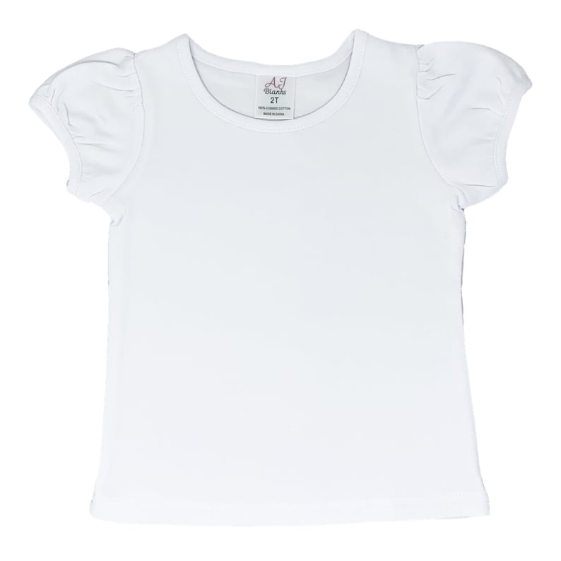 May include: White short-sleeved t-shirt with puffed sleeves. The shirt has a round neckline and a tag that reads "AJ Blanks 2T 100% combed cotton made in China".