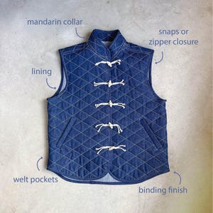 May include: A dark blue quilted denim waistcoat featuring a mandarin collar, five white rope toggle closures, and two angled welt pockets. The garment is constructed with a diamond-stitched pattern, a finished binding edge, and an internal lining.