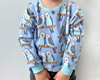 Fröhlicher Oversize-Pullover für Kinder, unisex, Design „Wellensittiche”, Bio