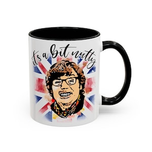 May include: White ceramic mug with a black interior and handle. The mug features a watercolor illustration of a man wearing glasses, with the Union Jack flag in the background. The text "it's a bit nutty" is written above the illustration.