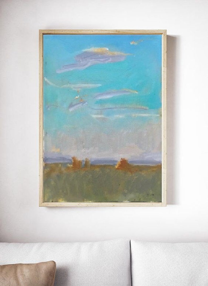 May include: A framed abstract landscape painting with a blue sky, white clouds, and a green field with brown brushstrokes.