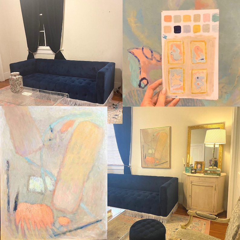 May include: A blue velvet sofa with fringe trim sits in a room with a painting on the wall. The painting is abstract and features a variety of colors, including pink, yellow, and blue.