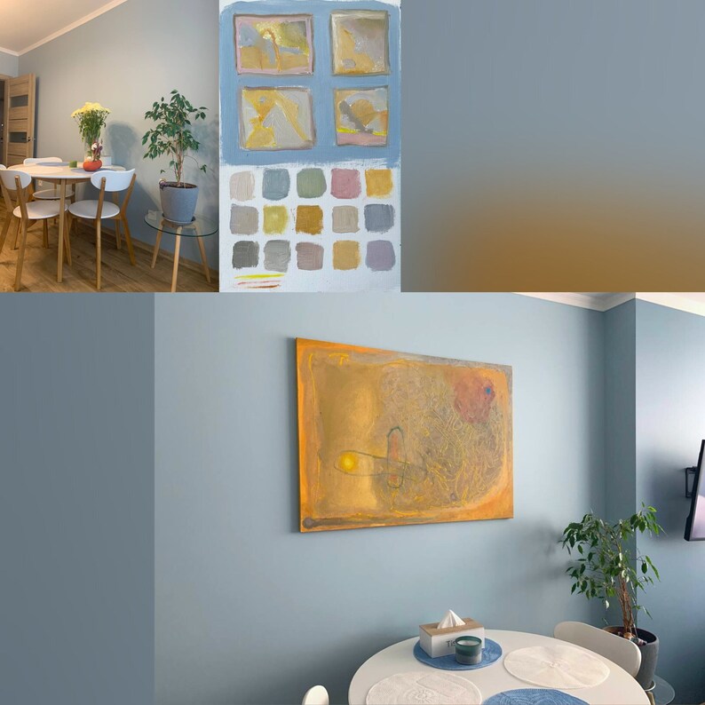May include: A light blue wall with a painting of abstract shapes in shades of yellow, orange, and brown. The painting is hanging above a round white table with a white tablecloth and two placemats. A small plant is in the corner of the room.
